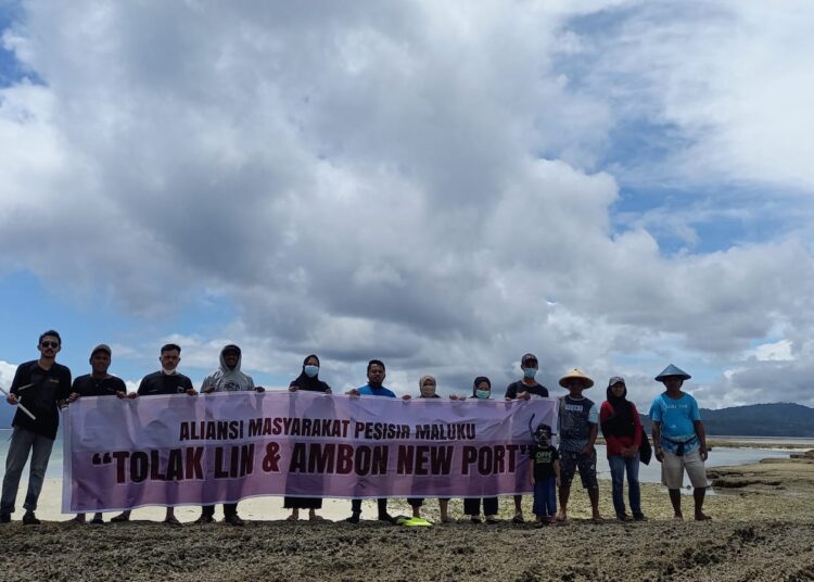 Aliansi Masyarakat Pesisir Maluku membentang spanduk penolakan LIN Dan Ambon New Port  Yusuf berenang selama dua jam dan tiba di Pulau Pombo, Maluku Tengah, Senin (16/8/2021) Foto : istimewa