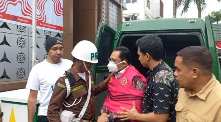 Mantan Sekda SBT Jafar Kwairumaratu (rompi tahanan warna merah) saat turun dari mobil tahanan menuju ruang pemeriksaan kantor Kejati Maluku, Sabtu (17/8/2024). (Foto: Husen Toisuta/Ambonkita.com)